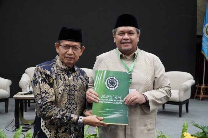 
					Ketua SC Mukerda II 2025 KH Yusuf Aman menyerahkan Hasil Mukerda ke Ketua Umum KH Muhammad Faiz (Infokom)